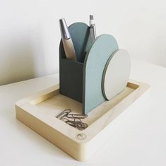 a pen holder with scissors and other office supplies