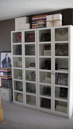 a large white book case with many items on it