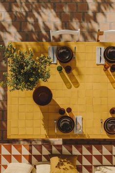 an overhead view of a yellow table and chairs