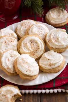 a plate filled with frosted cookies on top of a table