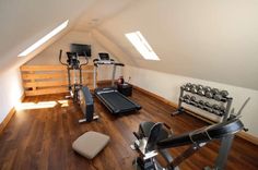 an attic gym with treadmills and exercise equipment