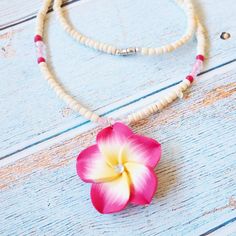 Colorful plumeria flower adorned with a sparkly gem in the center. Hand strung through a beaded necklace of wooden & color seed beads. White wooden seed beads Hand formed plumeria flower Barrel fastener Hand-made, each unique Pendant: ~ 1 1/2" Length: ~ 17" Hawaiian Necklace, Pink Pendant, Coconut Girl, Unique Pendant, Tropical Flowers, Flower Pendant, Seed Beads, Barrel, Coconut