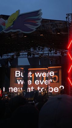 the stage is lit up at night and people are watching it