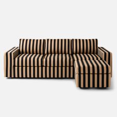 a black and white striped couch sitting on top of a wooden floor