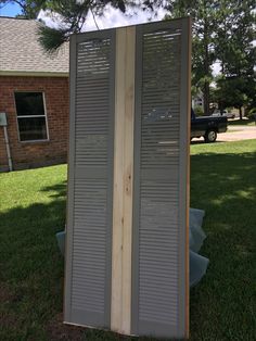 a large wooden door sitting in the grass