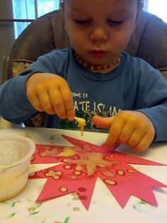 a little boy that is sitting at a table