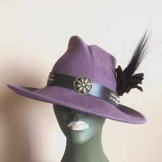 The allure of a well made fedora. A modern fedora is created in mauve wool felt imported from Poland. Hand-crafted in USA with adjustable headband. The feather is not sewn and the hat can also be worn without it . Adjustable Flat Brim Purple Felt Hat, Adjustable Purple Felt Hat With Short Brim, Adjustable Purple Felt Hat With Flat Brim, Purple Adjustable Flat Brim Felt Hat, Adjustable Wide Brim Purple Fedora, Adjustable Purple Brimmed Fedora, Adjustable Purple Fedora With Short Brim, Purple Adjustable Short Brim Fedora, Adjustable Purple Short Brim Fedora