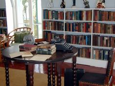 there is a table with books on it in the room