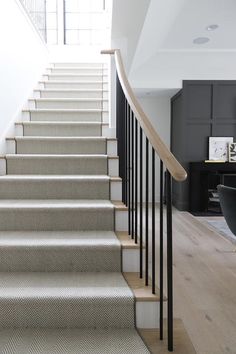 a staircase with carpeted steps leading up to the second floor in a modern home