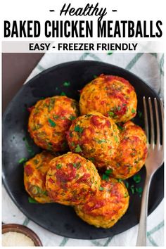 baked chicken meatballs on a black plate with a fork