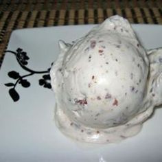 a white plate topped with a scoop of ice cream