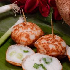 some food is sitting on a green plate with red flowers in the backgroud