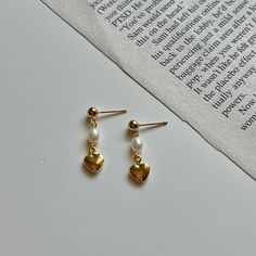 Drop gold heart pearl earrings perfect for everyday wear! Mini Heart Pearl Earrings,Gold Heart Earrings Dangle,Dainty Pearl Earring,Pearl Drop Earrings,Minimalist Earrings,Gift For Her Mini huggies pearl earrings with gold heart is now available in this link https://www.etsy.com/listing/959497029/gold-heart-pearl-earringhoop-gold?ref=shop_home_active_8&pro=1&frs=1 Product Detail -Size: Freshwater pearls are about 3-3.5mm -Earring pin is made with .925 Sterling Silver with 14k gold filled Pearl Huggies, Heart Pearl Earrings, Gold Heart Earrings, Earring Pearl, Pearl Earrings Gold, Gold Heart Earring, Gold Pearl Earrings, Pearl Earring