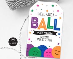 a ball of yarn next to a tag with the words, we'll have a ball this year welcome back to school