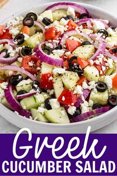 greek cucumber salad with olives, onions and feta cheese in a white bowl