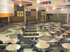 an empty cafeteria with tables and chairs