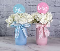 two vases with baby's breath flowers in them