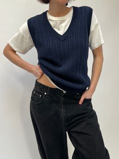 Classic navy blue vest with a v-neck and cable knit detailing throughout. The vest has ribbing throughout the hemlines. Perfect styled over a white cotton tee paired with high rise denim and everyday Rachel Hoops from our in house line. 100% cotton Tag reads Izod Club Recommended for size xs-m, depending on the desired fit. Modeled on a small frame. Please refer to the measurements listed below: Measures approximately: 38" bust / 26" shoulder to hemline If you would like additional info or image Navy Sweater Vest Outfit, Blue Sweater Vest Outfit, White Tee Shirt Outfit, Blue Vest Outfit, Knitted Vest Outfit, Navy Cable Knit Sweater, Cable Knit Sweater Vest, Sweater Vest Outfit, Navy Blue Vest