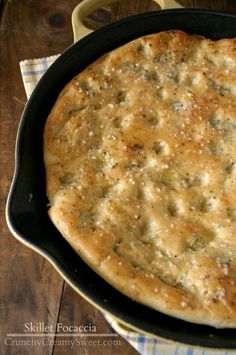 a pan filled with food sitting on top of a wooden table