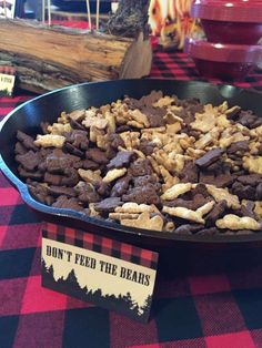 a pan filled with dog treats sitting on top of a red and black checkered table cloth