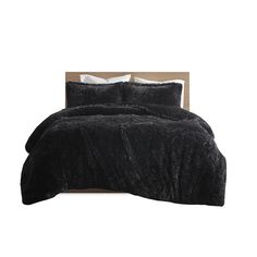 a bed with black comforter and pillows on it