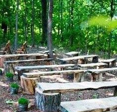 there are many benches made out of logs in the woods