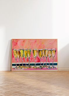 a group of wine glasses sitting on top of a wooden floor next to a wall