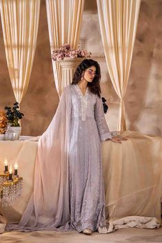 SKU:- 2315 Price for Shirt and inner only. This ethereal maxi dress is crafted from luxurious chiffon fabric adorned with intricate thread embroidery, embellished with shimmering pearls, enchanting French knots, and delicate beading.This festive ensemble is an absolute essential for the Eid season, showcasing agraceful flow and an exquisite blend of embellishments. The two-toned dupattaelegantly complements the overall look, elevating the ensemble to a sublime fashionstatement that captures the Floor-length Pearl Embroidered Dress For Eid, Floor-length Pearl Embroidery Dress For Eid, Floor-length Dresses With Pearl Embroidery For Eid, Elegant Maxi Gown With Resham Embroidery, Elegant Maxi Length Resham Embroidery Gown, Elegant Long Gown For Reception, Evening Dresses In Georgette With Pearl Embroidery, Evening Dresses With Chikankari Embroidery For Eid, Evening Dresses With Pearl Embroidery In Georgette