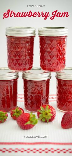 strawberry jam in glass jars with strawberries on the side and text overlay reading low sugar strawberry jam