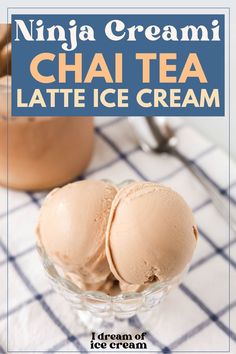 two scoops of ice cream sitting in a glass bowl on top of a table