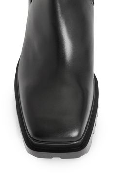 A treaded lug sole and chunky block heel give modern shape to this leather Chelsea boot. 2 1/2" heel 7 3/4" shaft Pull-on style with elastic gore insets Leather and textile upper and lining/synthetic sole Made in Portugal Leather Knee-high Chunky Platform Boots, Modern Platform Boots With Leather Sole For Work, Modern Leather Sole Platform Boots For Work, Modern Leather-sole Platform Boots For Work, Calf Leather Platform Boots With Lug Sole For Work, Modern Moto Boots With Reinforced Heel For Work, Modern Chelsea Boots With Lug Sole, Black Calf Leather Platform Boots With Block Heel, Modern Ankle Boots With Lug Sole