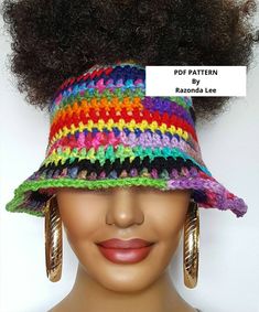 a woman wearing a multicolored crochet hat with large hoop earrings on her head