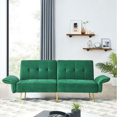 a green couch sitting on top of a white rug