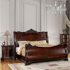 a bed sitting on top of a hard wood floor next to a dresser and mirror