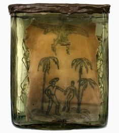 a glass block with an image of two people holding hands in front of palm trees