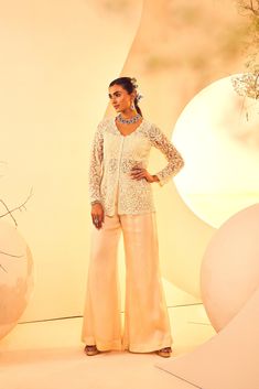 Featuring a pearlwork hand-embroidered jacket with flared pants. It comes with a bralet From Aneesh Agarwaal's Naksh collection. DELIVERY TIMEPlease allow 8-12 weeks for your outfit to arrive. FABRIC DETAILSPants, Satin Organza, Jacket-Tulle Professional cleaning only. Elegant Wedding Pants For Festive Season, Elegant Festive Wedding Pants, Elegant Long Sleeve Pant Set For Festive Occasions, Evening Party Wear Palazzo Set With Zari Work, Formal Semi-stitched Sets With Pearl Embroidery, Elegant Designer Long Sleeve Pant Set, Elegant Long Sleeve Designer Pant Set, Festive Evening Palazzo Set With Zari Work, Elegant Designer Pants For Festive Occasions