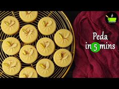 some cookies are sitting on a wire rack next to a red towel and a bowl