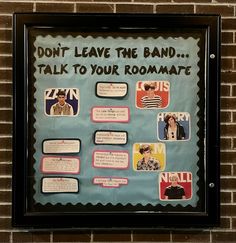 a bulletin board that has been placed on a brick wall with words and pictures attached to it