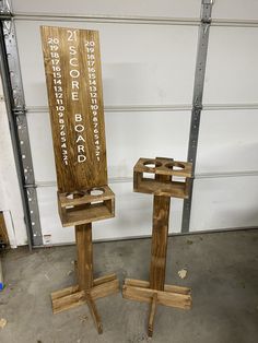 two wooden chairs sitting next to each other in front of a garage door with words on them