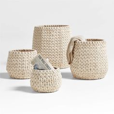 three woven baskets with handles, one holding money and the other sitting on top of it