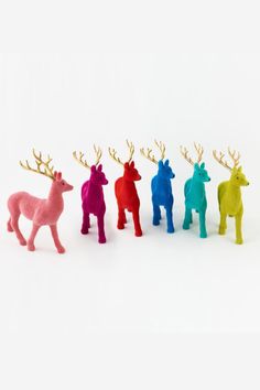 four different colored deer figurines in the shape of animals