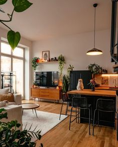 a living room filled with furniture and a flat screen tv sitting on top of a wooden table