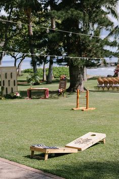 a wooden bench sitting on top of a lush green field