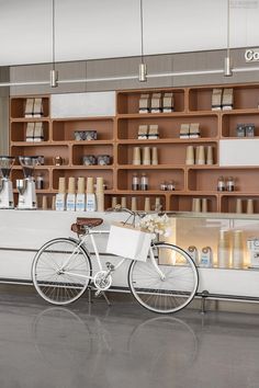 a white bicycle parked in front of a counter