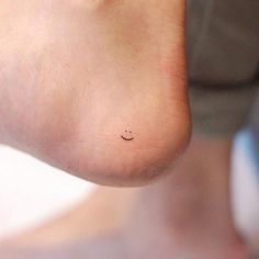 a person's foot with a small smiley face on it