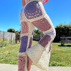 a woman wearing crocheted leggings standing in the grass