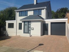 a large white house with two garage doors