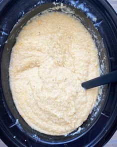 a crock pot filled with batter on top of a wooden table