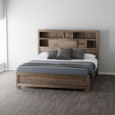 a large bed sitting in the middle of a room next to a wall mounted book shelf