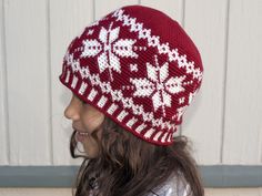 a woman wearing a red and white knitted hat